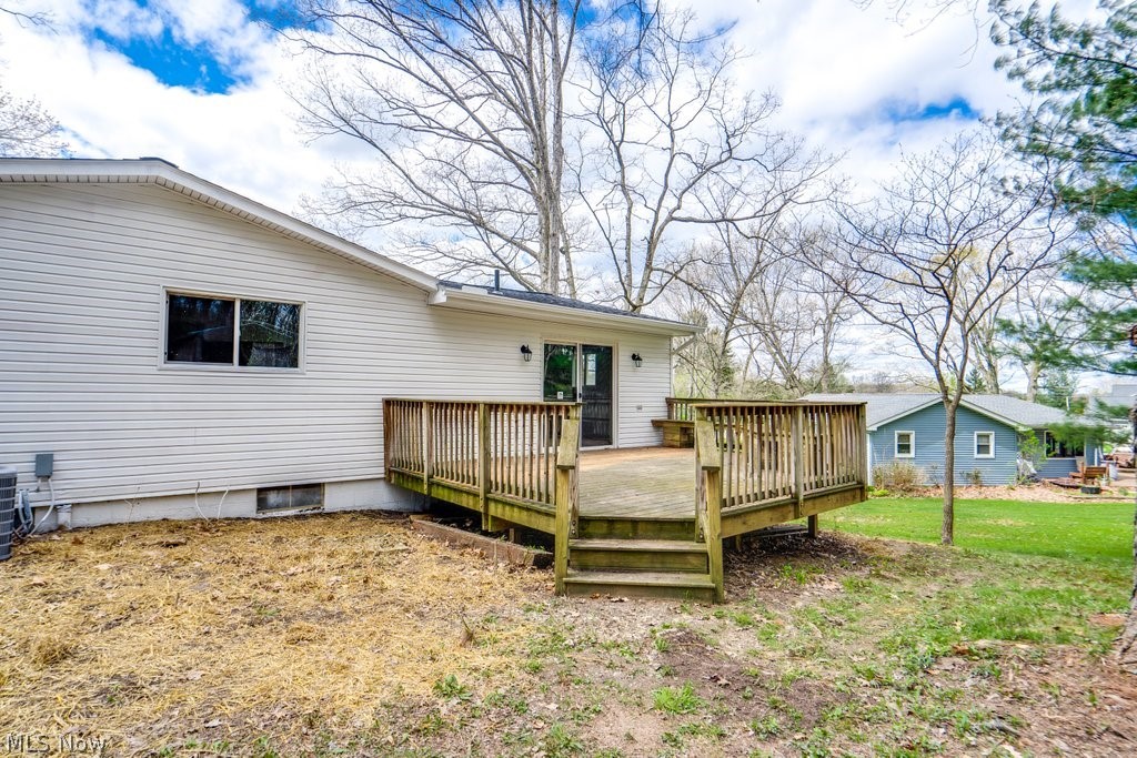 4596 Hattrick Road Rootstown, OH 44272 - Photo 4 of 45 Back of property with a deck, a yard, and central AC unit