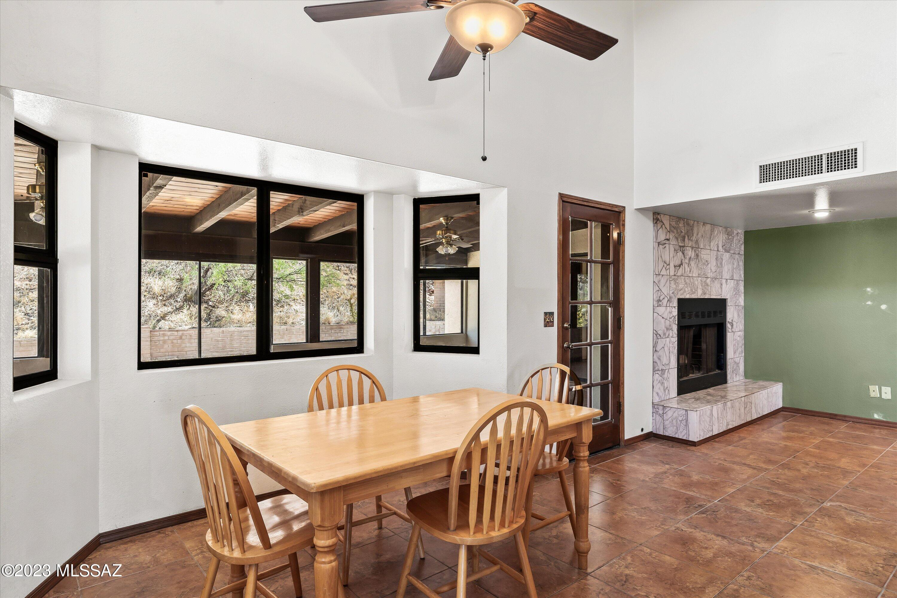 1226 Avenida Gloriosa Rio Rico, AZ 85648 - Photo 13 of 46 a view of a dining room with furniture window and wooden floor