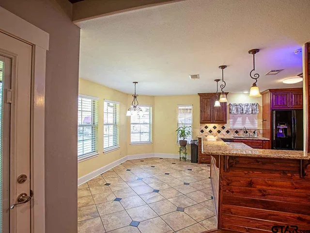 a large space with lots of counter furniture and a fireplace