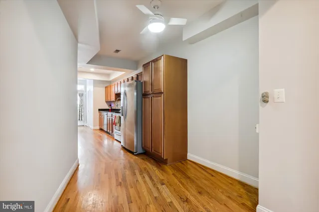 a view of a hallway with wooden floor