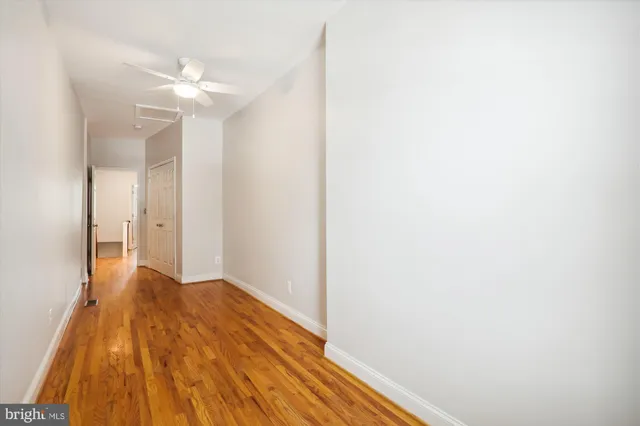 a view of a hallway with wooden floor