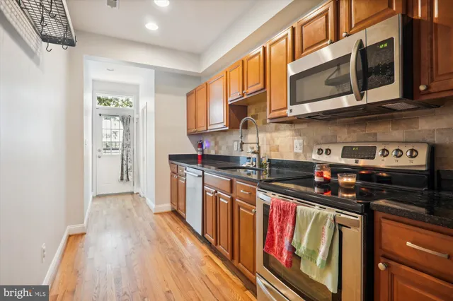 a kitchen with stainless steel appliances granite countertop a stove and a sink