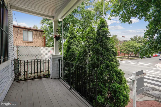 a view of a porch with wooden floor and fence