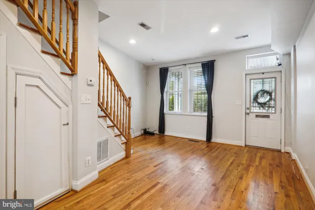 a view of an entryway with wooden floor and stairs