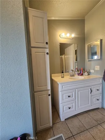 a bedroom with bed and a flat screen tv