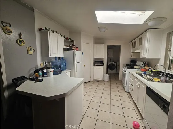 a kitchen with a sink a stove and chairs