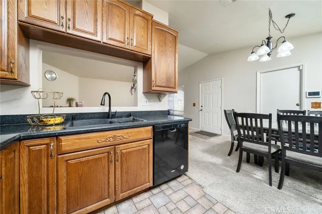 a kitchen with stainless steel appliances granite countertop a sink and cabinets