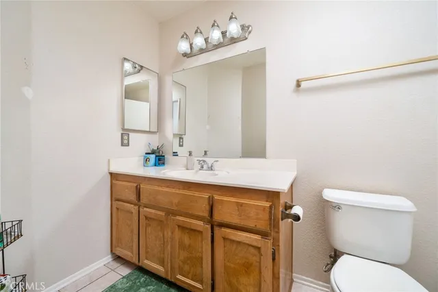 a bathroom with a sink vanity mirror and toilet