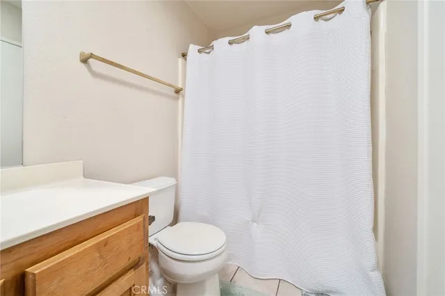 a bathroom with a sink a toilet and a shower