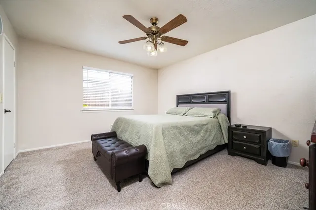 a bedroom with a bed and window