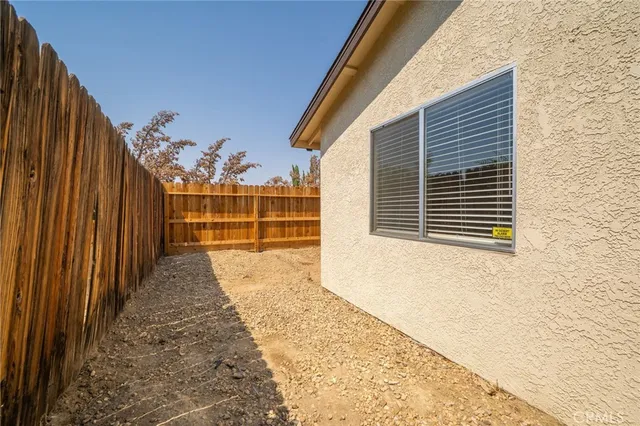 a view of a porch with wooden floor and fence