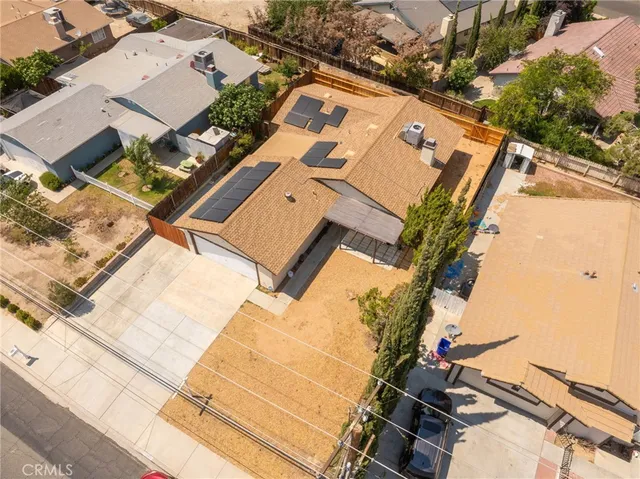 an aerial view of a house with a yard