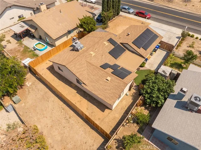 an aerial view of a house with a backyard