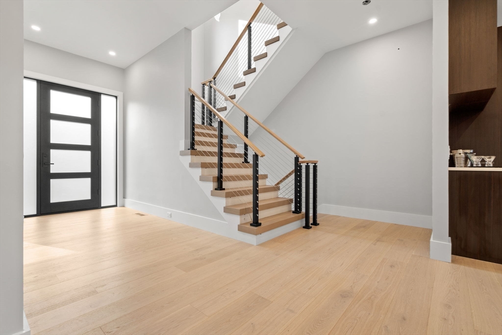 56 Upland Road Newton, MA 02468 - Photo 17 of 41 a view of an empty room with stairs and a window