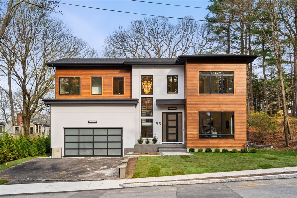 56 Upland Road Newton, MA 02468 - Photo 2 of 41 a front view of a house with a garden