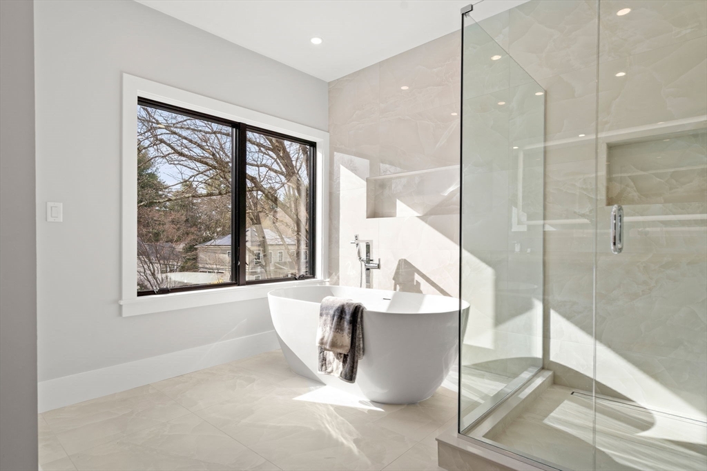 56 Upland Road Newton, MA 02468 - Photo 22 of 41 a large glass door with a glass door and shower