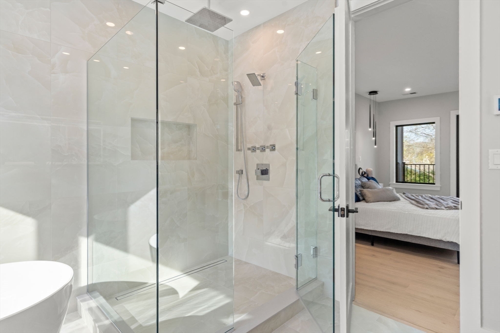 56 Upland Road Newton, MA 02468 - Photo 23 of 41 a bathroom with a shower and a tub