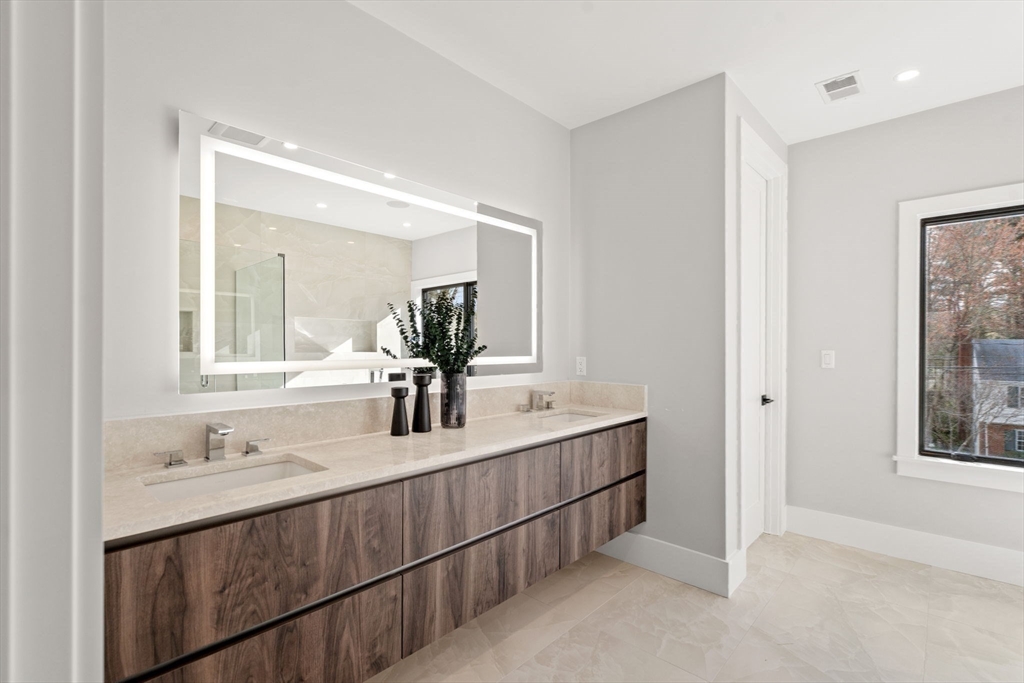 56 Upland Road Newton, MA 02468 - Photo 24 of 41 a bathroom with double vanity sink and a mirror
