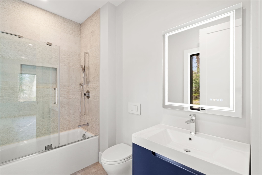 56 Upland Road Newton, MA 02468 - Photo 27 of 41 a bathroom with a bathtub shower sink vanity mirror and toilet
