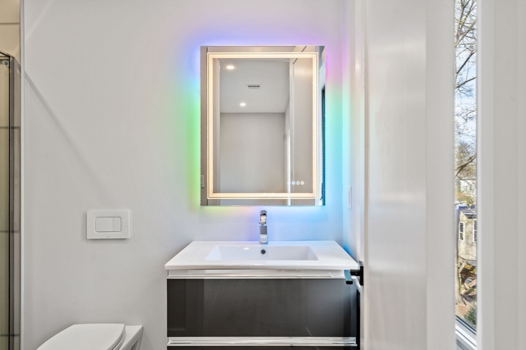 56 Upland Road Newton, MA 02468 - Photo 33 of 41 a bathroom with a sink a toilet and mirror
