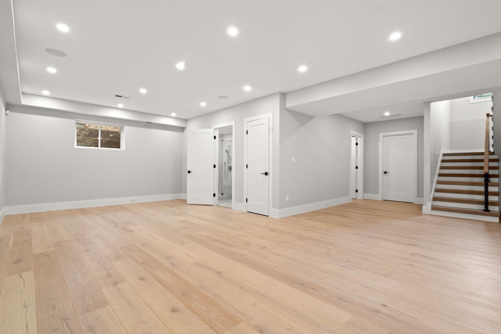 56 Upland Road Newton, MA 02468 - Photo 39 of 41 a view of an empty room with wooden floor