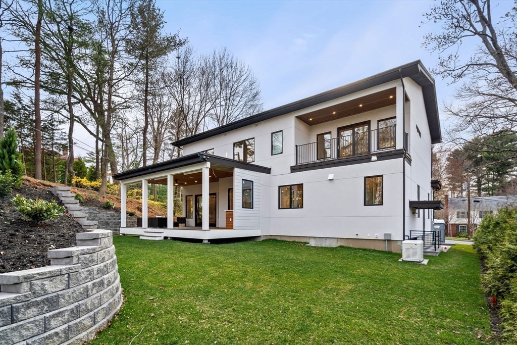 56 Upland Road Newton, MA 02468 - Photo 4 of 41 a front view of a house with a garden and yard