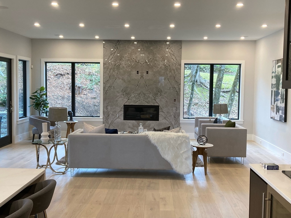 56 Upland Road Newton, MA 02468 - Photo 10 of 41 a living room with furniture floor to ceiling window and a fireplace