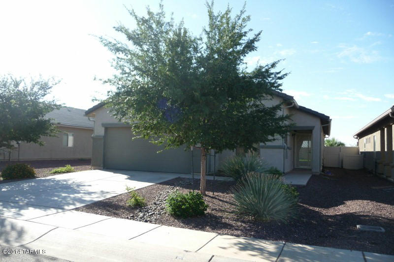 21321 East Reunion Road Red Rock, AZ 85145 - Photo 2 of 34 a front view of a house with a yard and trees