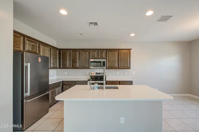 a kitchen with stainless steel appliances a refrigerator and a stove