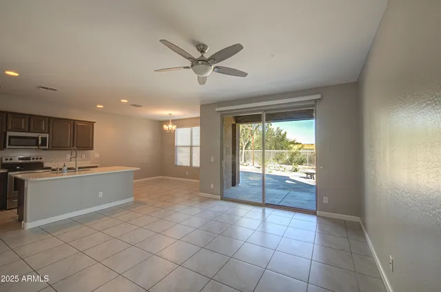 a large kitchen with a window and stainless steel appliances