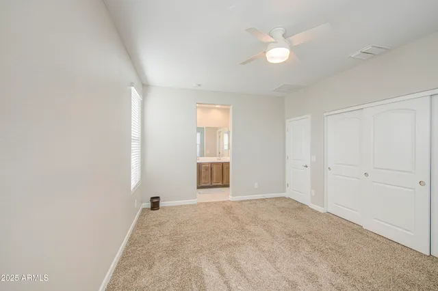 an empty room with windows and closet