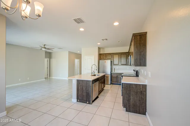 a kitchen with stainless steel appliances a sink and cabinets
