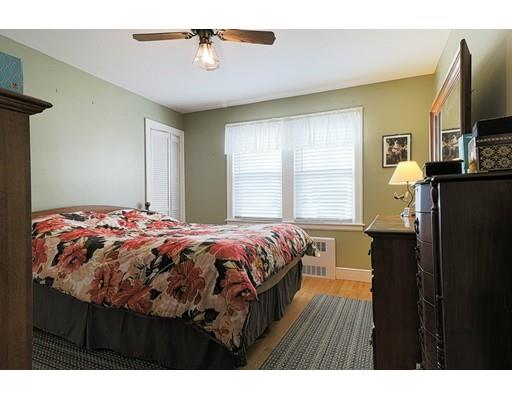 24 Devens Road Worcester, MA 01606 - Photo 13 of 25 a bedroom with a bed and a flat tv screen on dresser