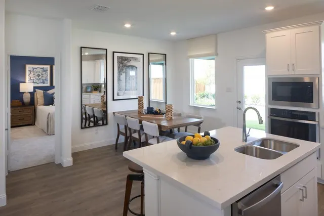 a living room with furniture and kitchen view