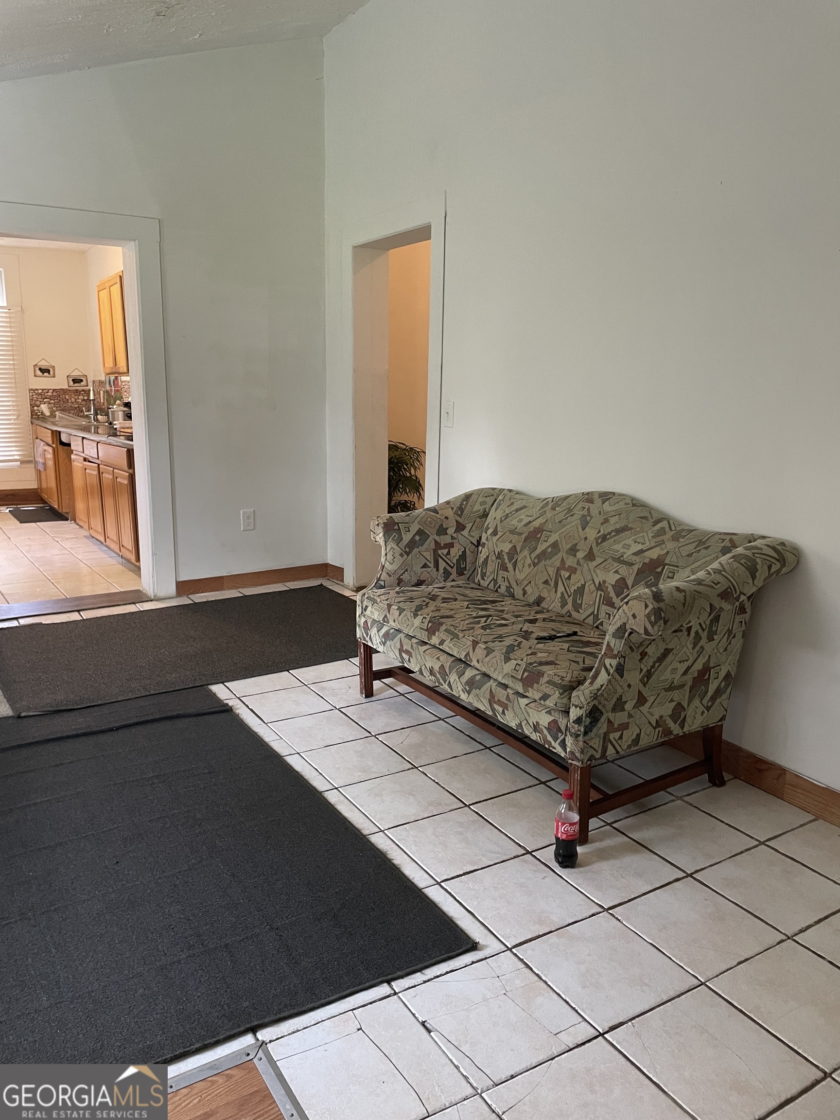 304 East 19th Street Rome, GA 30161 - Photo 11 of 15 a living room with a bed and a dresser next to a window