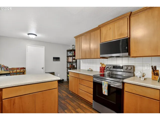 a kitchen with stainless steel appliances a sink stove and refrigerator