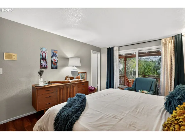 a bed room with a bed and a large window