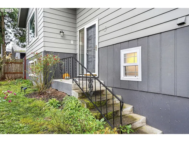 a view of a house with backyard and sitting area