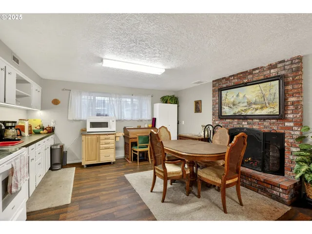 a kitchen with furniture and wooden floor