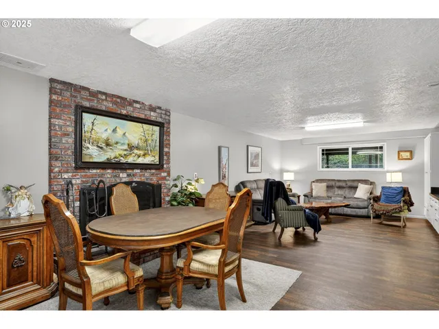 a living room with furniture a flat screen tv and a large window