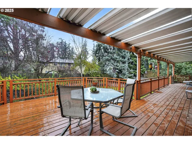 a balcony with wooden floor and outdoor seating