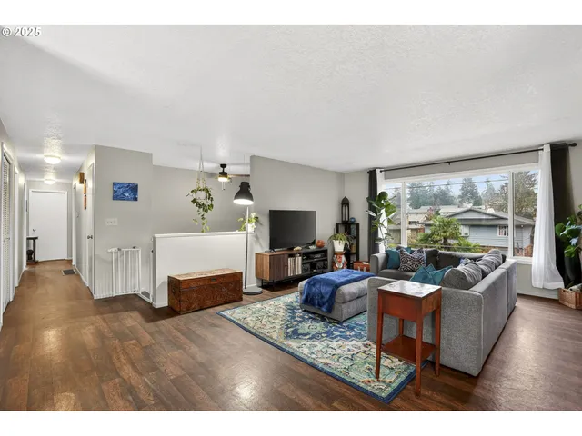 a living room with furniture large window and a flat screen tv