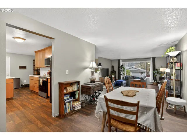 a living room with furniture and a dining table