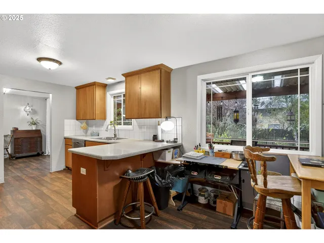 a view of a dining room with furniture and a large window