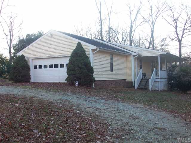 7112 Blalock Road Bahama, NC 27503 - Photo 2 of 12 a view of a house with a yard and garage
