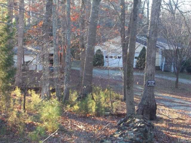 7112 Blalock Road Bahama, NC 27503 - Photo 4 of 12 a view of a yard with trees