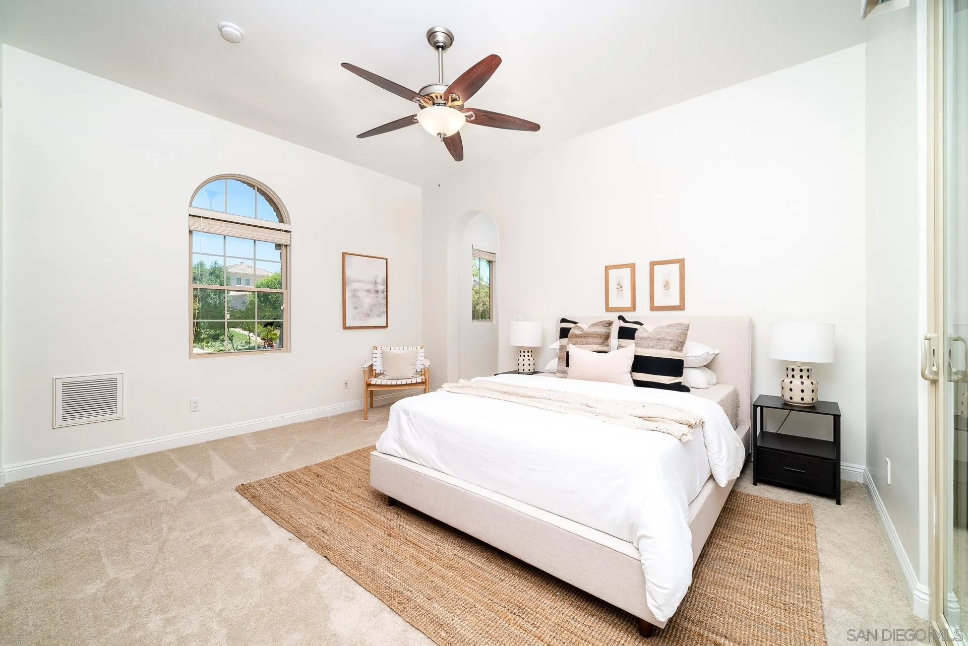 14757 Whispering Ridge Road San Diego, CA 92131 - Photo 11 of 48 a bedroom with a large bed and a chandelier