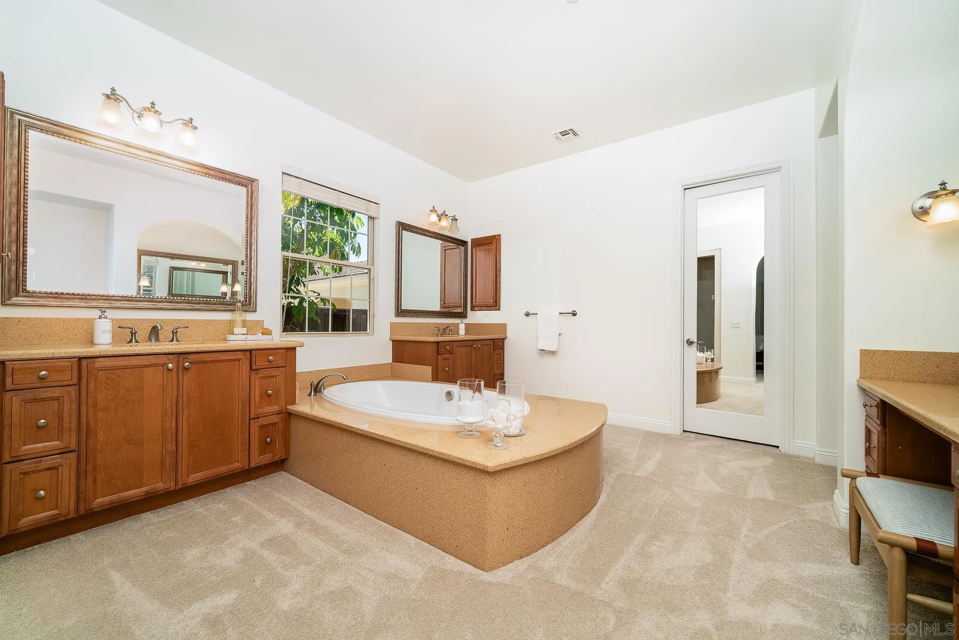 14757 Whispering Ridge Road San Diego, CA 92131 - Photo 19 of 48 a bathroom with a sink a bathtub a mirror and a vanity