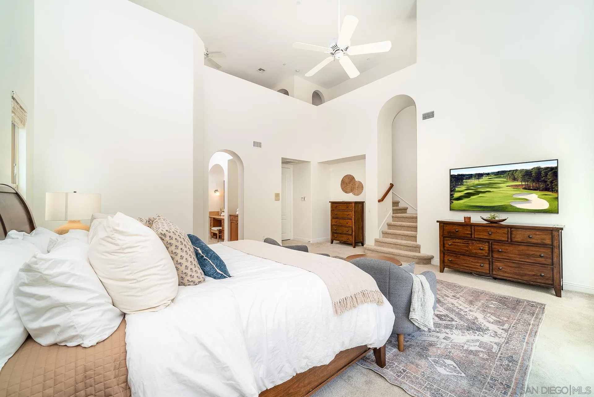 14757 Whispering Ridge Road San Diego, CA 92131 - Photo 20 of 48 a bedroom with a bed and dresser with mirror