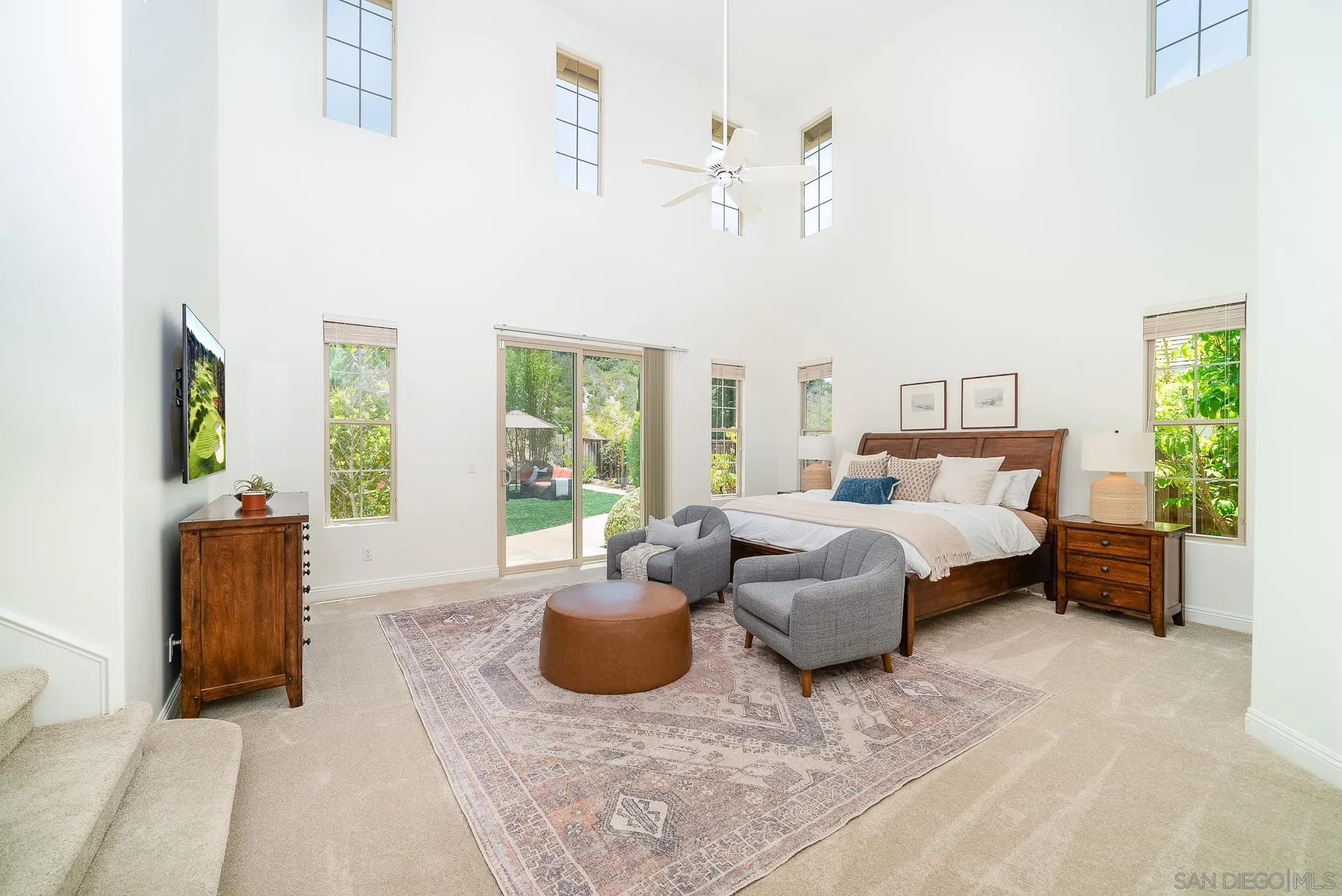 14757 Whispering Ridge Road San Diego, CA 92131 - Photo 21 of 48 a bedroom with a bed and large windows